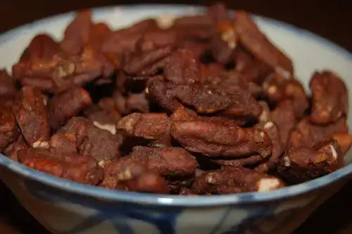 Roasted pecans in bowl, healthy snack for heart and brain health