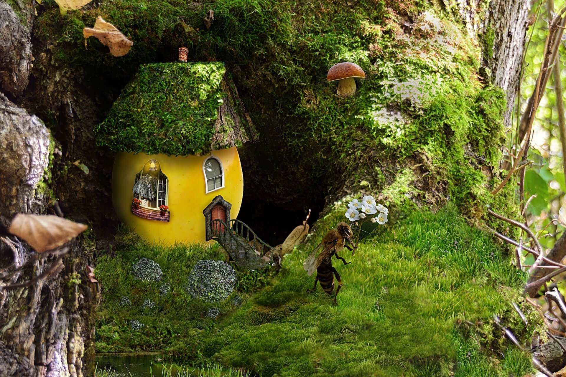 Whimsical yellow fairy house with sheet moss roof in lush forest