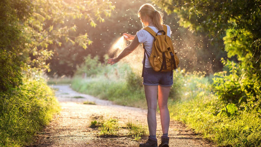 Person wearing yellow canvas backpack with black straps on dirt path
