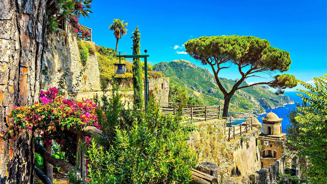 Stone pathway winds through lush greenery, pink flowers in crafted landscape