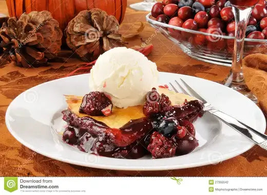 Scoop of vanilla ice cream on Our Blackberry Cobbler Recipe pie