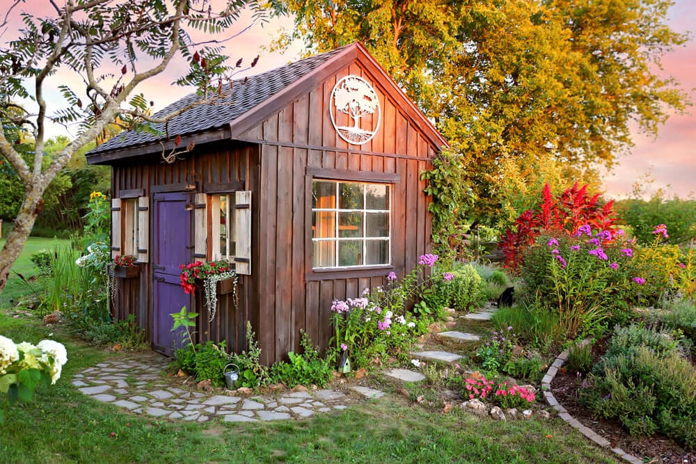 Charming rustic wooden garden shed with dark brown exterior and purple door