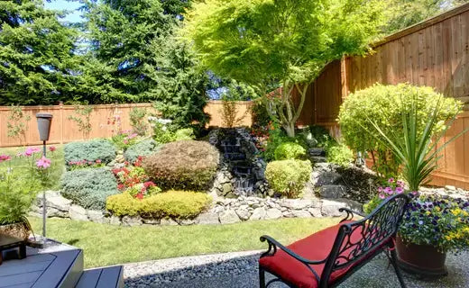 Red cushioned wrought iron bench for enhancing small spaces