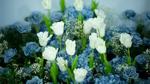 Lush white tulips blue hydrangeas babys breath garden centerpiece