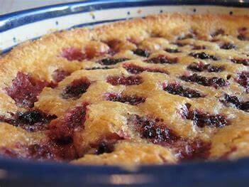 Golden-brown blackberry pie with lattice crust in blue dish