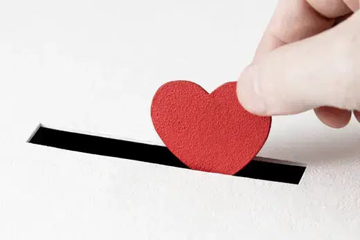 Red textured paper heart inserted into slot for moss gardening