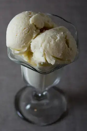 Creamy vanilla snow cream in clear glass sundae dish