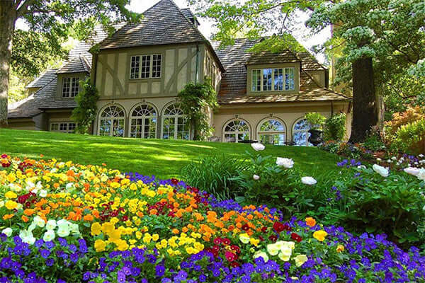 Charming half-timbered house amid lush perennials greenery