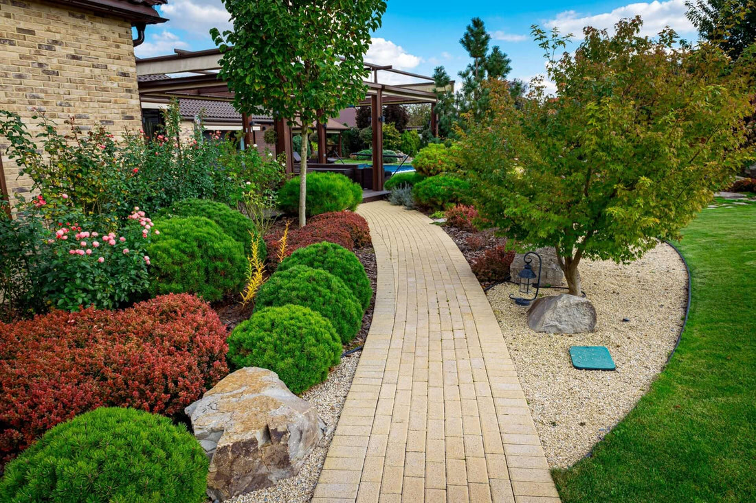 Zen garden beige brick pathway winding through landscaped shrubs and trees