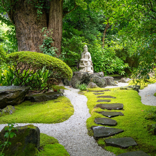 Serene marble statue in Tennessee garden with moss potential