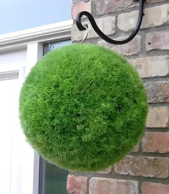 Vibrant green spherical moss ball topiary on black metal hook