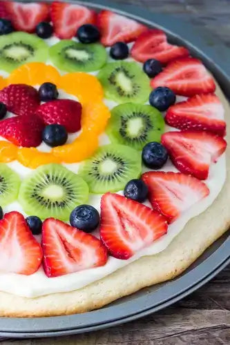 Vibrant rainbow fruit pizza recipe with strawberries kiwi blueberries oranges