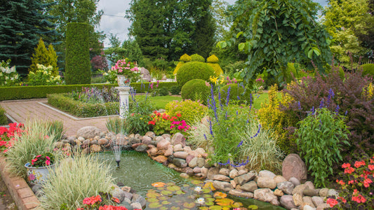 Serene MERGE garden pond with colorful flowers and river rocks
