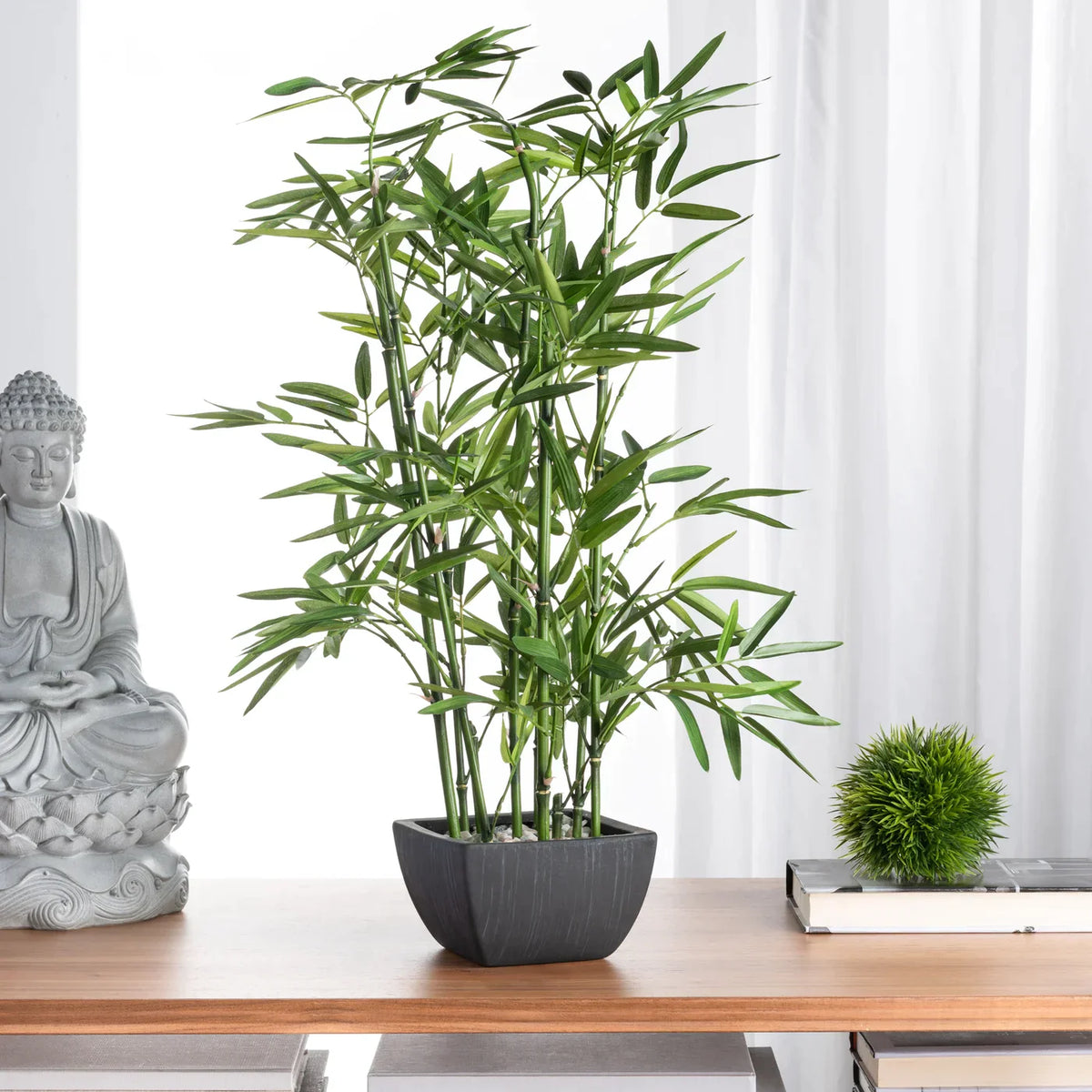Tall lush green artificial bamboo plant in sleek black rectangular pot