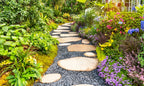 Winding beige stone path in dark gravel for native plant garden zone
