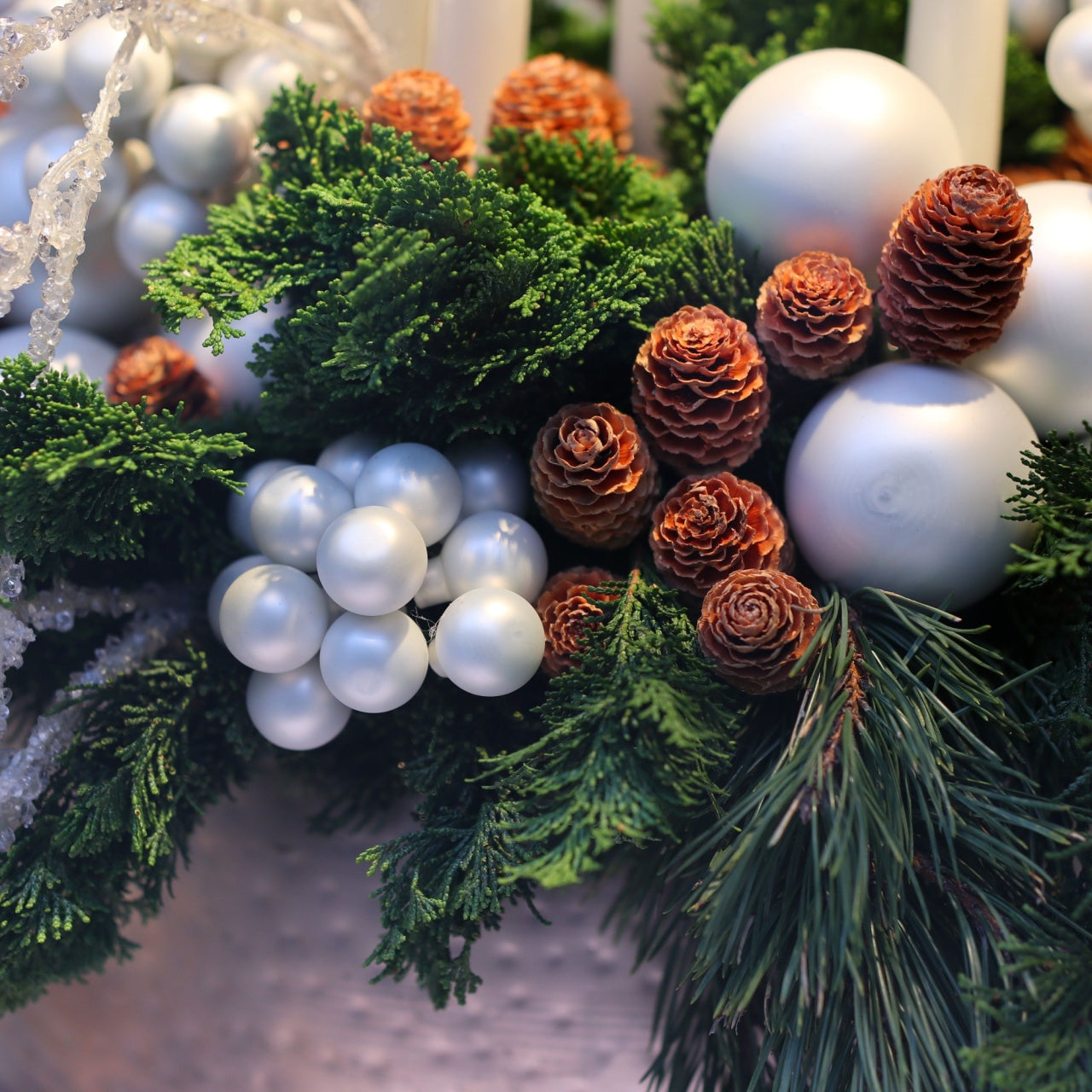 Glossy white ornaments with green pine branches and pinecones, 3 pack